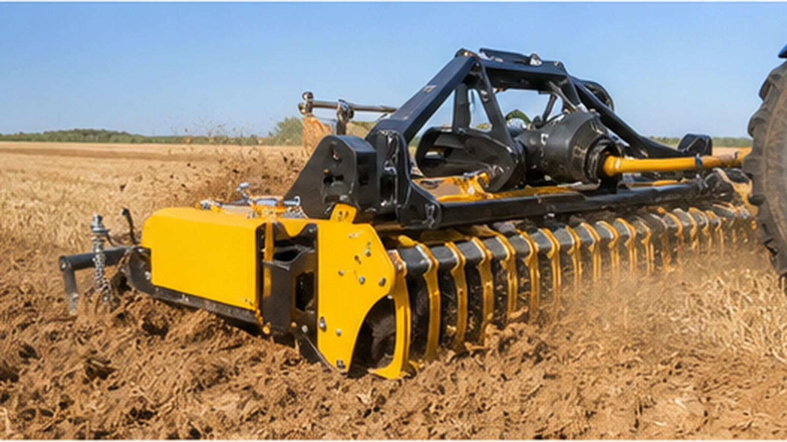Rotary tillage harrow attachment working in a clean golden field